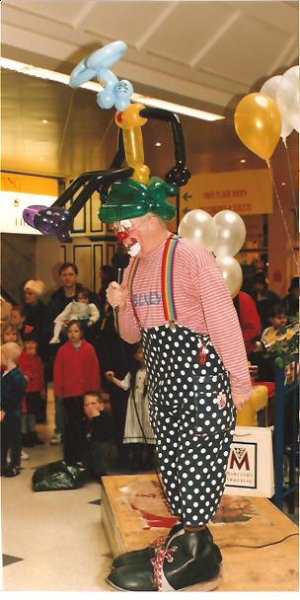 Clown Bluey on the mic at the Easter Bonnet Competition, Marlands Shop Mall